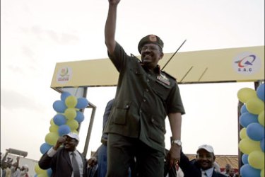 afp : Sudanese President Omar al-Beshir waves his cane as he attends the inaugration ceremony of the Safat Aviation Complex (SAC) in Karari, north of Khartoum, on July 5, 2009.