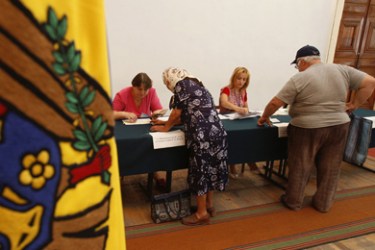 Moldovan citizens wait to cast their ballots at a polling station in Chisinau July 29, 2009. Moldovans began voting in a snap parliamentary election on Wednesday, facing a choice