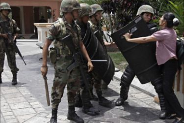 Soldiers stop a pedestrian from crossing through a park before a protest in San Pedro Sula July 6, 2009. The United States on Monday condemned violence against protesters