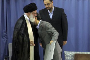 r : Iranian President Mahmoud Ahmadinejad (R) kisses Supreme Leader Ayatollah Ali Khamenei after receiving a certificate declaring him as president of the Islamic Republic