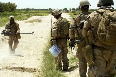 afp : US Marines of 1st Combat Engineer Battalion of 2nd Marine Expeditionary Brigade inspect the road where they found a buried Improvised Explosive Device (IED) in Nawa