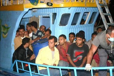epa000259836 Some of the immigrants who were picked up off southern Italy on Tuesday, 24 August 2004, and taken to a reception centre on the island of Lampedusa off Sicily