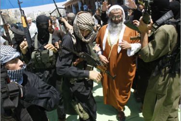 AFP Abdul Latif Musa (2nd R), a representative the radical Palestinian Islamist group Jund Ansar Allah, is surrounded by armed members of his radical group after the Friday prayer sermon in the southern Gaza Strip town of Rafah
