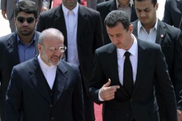 Syrian President Bashar al-Assad (front R) speaks with Iranian Foreign Minister Manouchehr Mottaki (front L) as he arrives at Mehrabad airport in Tehran