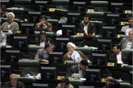 Iranian law makers listen to a speech by President Mahmoud Ahmadinejad at the parliament in Tehran on August 30, 2009.
