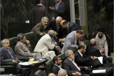 Iranian MPs chat with nominated ministers during a debate over the proposed cabinet of President Mahmoud Ahmadinejad at the parliament in Tehran on September 2, 2009