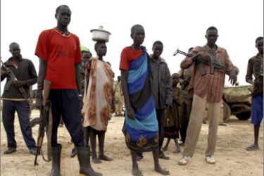 Residents of Duk Padiet stand near an airstrip two days after their village was attacked by the neighbouring Lou Nuer tribe in Southern Sudan, September 22, 2009.
