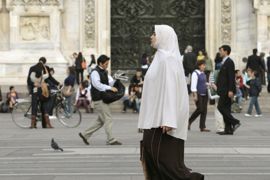 A Muslim woman wearing a hijab walks in Duomo square in Milan October 7, 2009. Italy's anti-immigration Northern League party is pushing for legislation to prosecute women