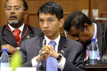 r : Madagascar's President Andry Rajoelina attends the second round of talks with the ousted president Marc Ravalomanana (not pictured) in the Mozambican capital