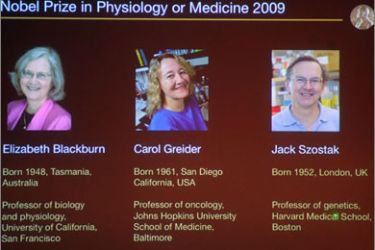 A picture taken from a screen as the Nobel Assembly at Karolinska Institute announces Elisabeth H. Blackburn, Carol W. Greider and Jack W. Szostak as the winners of the 2009