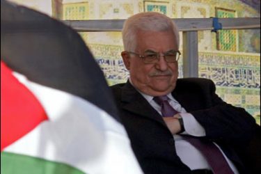 f/Palestinian Authority President Mahmud Abbas sits next to a national flag during his visit to the Arab-American University in the West Bank city of Jenin on October 13, 2009. Abbas' Fatah movement has agreed to an Egyptian proposal