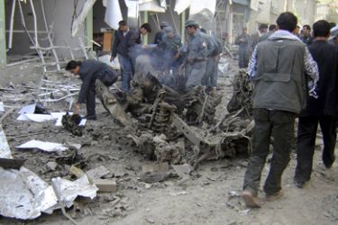 Afghan policemen investigate at the site of a blast in Kabul October 8, 2009. A large bomb exploded near the Indian embassy in the centre of the Afghan capital on Thursday,