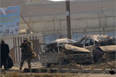 US and Afghan security forces gather at the site of a suicide attack in Kabul on November 13, 2009. Three foreign soldiers were wounded around 7:45 am in a suicide car bombing near the US-run NATO military base Camp Phoenix in Kabul on the Jalalabad