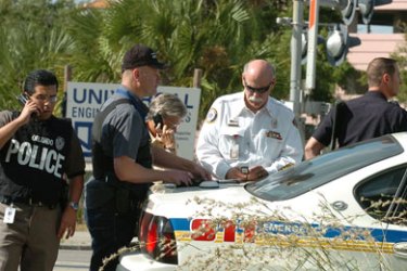 Orlando police surround the Legions Place office building, where a gunman opened fire wounding several people on November 6, 2009 in Orlando, Florida. The gunman, Jason Rodriguez, 40, who once worked as an engineer in one of the downtown offices, surrendered to the police after firing shots killing so far one and wounding five.