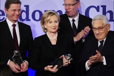 afp - US Secretary of State Hillary Clinton (2nd from L) and German Foreign Minister and vice-chancellor Guido Wester (L) pose with their trophies as former US secretary of state