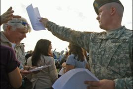 US Army soldiers distribute the official list of casualties of the 05 November shooting spree at Fort Hood before it is released to the media on November 7, 2009 in front of III Corps headquarters at Fort Hood, Texas.