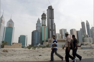 Men walk at the construction site of Dubai's Business Bay in the Gulf emirate on November 29, 2009. Dubai's shock alert of possible debt default will send Gulf markets, mainly in Dubai and Abu Dhabi, plunging when