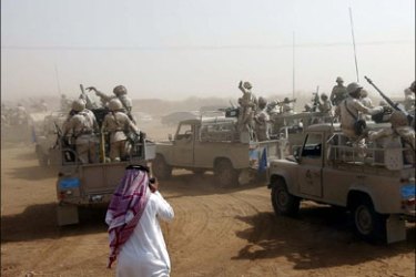 r : Saudi troops ride in their transports in Jizan near the border with Yemen November 10, 2009. Saudi Arabia said on Tuesday it would continue its offensive against Yemeni