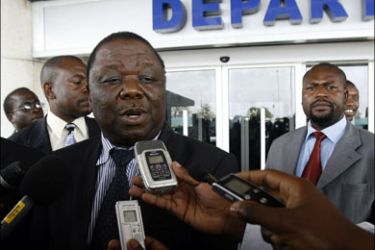 afp : Zimbabwean Prime Minister Morgan Tsvangirai talks to journalists at Harare international airport on November 19, 2009 before his departure to Morroco and Libya.The Prime