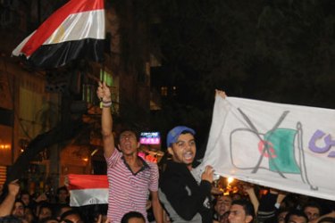 Hundreds of Egyptians hold up banners during a protest on November 19, 2009 near the Algerian embassy in Cairo after tension between both countries escalated following the disqualification of Egypt from the 2010 World Cup in a make-or-break World Cup qualification play-off the day before.