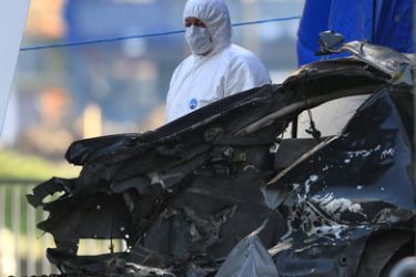 A Police forensic team remove a car in front of the Policing Board headquarters in Belfast, Northern Ireland, on November 23, 2009. Northern Ireland was on edge Monday after a huge car bomb only just failed to cause devastation at the weekend, in a new threat to the long-troubled province's fragile peace process.