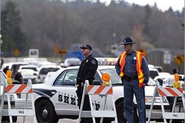 AFP - A road block prevents access to a street down which Lakewood Police Officers were killed in a coffee shop November 29, 2009 near Lakewood, Washington. A gunman shot and killed four Lakewood Police Officers in a Forza Coffee Company shop Sunday morning in what authorities are describing as