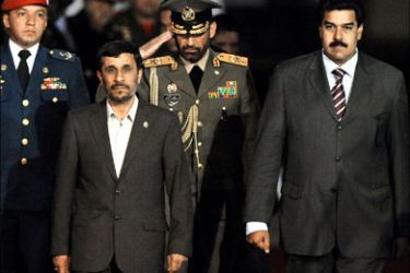 afp : Iranian President Mahmoud Ahmadinejad (L) walk with Venezuelan Foreign Minister Nicolas Maduro (R) upon arrival at Simon Bolivar International Airport in Caracas on