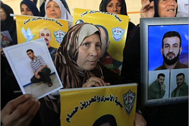 Palestinian families hold portraits of jailed relatives during a protest calling for their release from Israeli prisons on November 23, 2009 at the Red Cross offices in Gaza City.