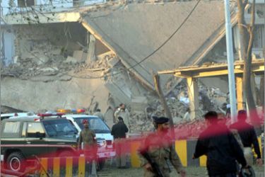 Pakistani security officials secure the site of a bomb blast at the Inter Services Intelligence (ISI) building in Peshawar on November 13, 2009.