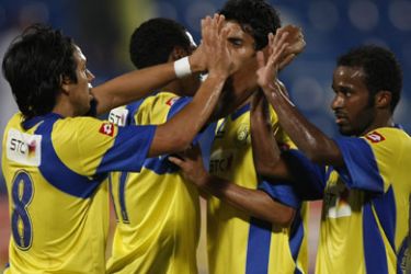 Saudi Arabia's Al-Nasser club Argentinian player Victor Alberto Figueroa (L) celebrates with teammates after his team's first goal against Al-Khor during their GCC clubs championship match in Doha on November 25, 2009.