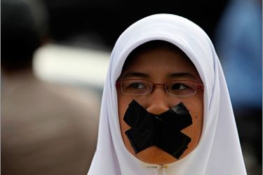 REUTERS / A student covers her mouth with tape during an Anti-Corruption Day rally in Jakarta December 9, 2009.