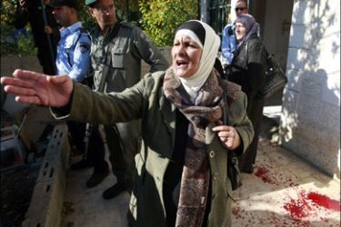 afp : A Palestinian woman reacts near Israeli security officers after Jewish settlers took over her family house in the Arab east Jerusalem neighborhood of Sheikh Jarrah on December