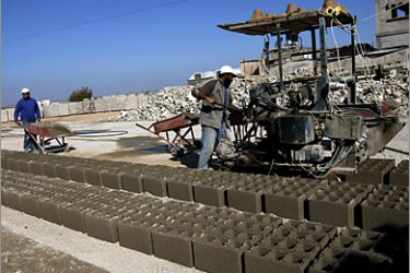 AFP - Palestinian workers recycle cement at a factory in Khan Yunis in the southern Gaza Strip on December 6, 2009. Cement factories are pulverising the ruins of destroyed