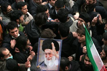 Iranian supporters (L) of defeated presidential candidate Mir Hossein Mousavi clash with supporters (R) of supreme leader Ayatollah Ali Khamenei (picture) at Tehran University in the Iranian capital on December 7, 2009. Iranian police firing tear gas clashed with crowds of protesters in central Tehran as opposition supporters used Students Day commemorations to stage fresh anti-government demonstrations.