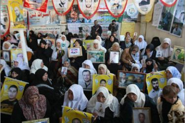 Palestinian women hold portraits of their jailed relatives during a protest calling for their release from Israeli prisons at the Red Cross offices in Gaza City on December 21, 2009.