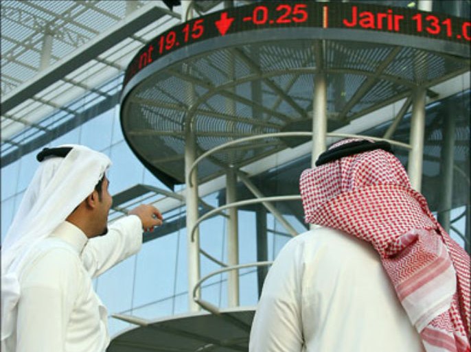 afp : Saudi men follow the market's movement outside the Saudi Stock Exchange or Tadawul in Riyadh on December 5, 2009. Saudi stocks closed down one percent as investors