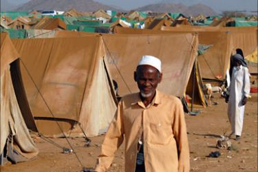 Displaced Yemenis from the Saada province walk outside tents at the Mazraq Internally Displaced People's (IDP) camp in northern Yemen on December 10, 2009