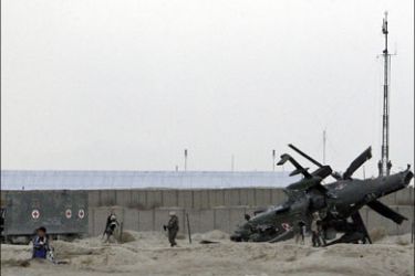 r : The wreckage of a NATO helicopter is seen in Ghazni province December 3, 2009. A NATO helicopter made a "hard landing" in Afghanistan southwest of the capital Kabul