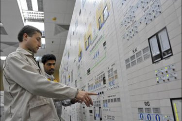 r : EDITORS' NOTE: Reuters and other foreign media are subject to Iranian restrictions on their ability to film or take pictures in Tehran. An Iranian operator (R) and a Russian operator monitor the nuclear power plant unit in Bushehr,
