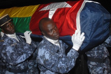 (FILES) Togolese gendarmes carry the coffin wrapped in the national flag of one of the victims of the Forces for the Liberation of the State of Cabinda-Military Position (FLEC-PM ) attack that killed two of members of the Togolese national football team on January 8, 2010