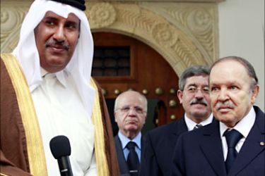 r_Qatar's Prime Minister Sheikh Hamad bin Jassim bin Jaber al-Thani (L) responds to journalists' questions after his meeting with Algeria's President Abdelaziz Bouteflika