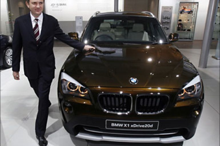 r_Peter Kronschnabl, president of BMW India Pvt. Ltd, poses with the company's new BMW X1 xDrive20d at India's Auto Expo in New Delhi January 5, 2010.