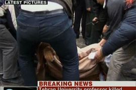 An image grab taken from Iran's English-language official Press TV station shows the body of an Iranian university lecturer killed in a remote-controlled bomb blast outside his Tehran residence being carried onto a stretcher at the scene of the explosion in the Iranian capital on Janauary 12, 2010.