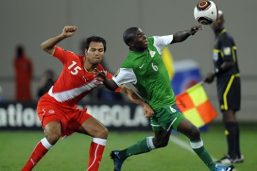Emmanuel Mbola of Zambia(R) and Zouheir Dhaouadi of Tunisia(L) fight for the ball during their group stage match at the African Cup of Nations CAN2010 at the Tundavala stadium in Lubango, Angola on January 13, 2010.