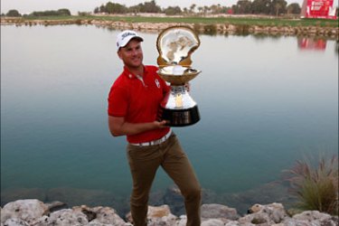r_Robert Karlsson of Sweden poses with the trophy after he won the Qatar Masters golf tournament in Doha January 31, 2010. REUTERS