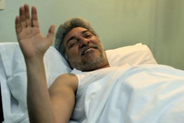 Paraguayan President Fernando Lugo waves from his hospital bed after a prostate operation in Asuncion January 8, 2010.