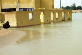 An Egyptian man squats in front of a flooded area in the Egyptian port town of El-Arish, 45 kilometres (30 miles) from the Gaza border, as heavy rains and floods pounded Egypt's Sinai peninsula, while five ports were closed due to the bad weather on January 18, 2010.