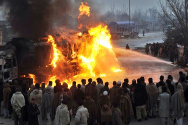 f-Onlookers watch firefighters extinguish a burning NATO supply truck outside Peshawar in January 23, 2010. Taliban militants attacked and destroyed a fuel tanker in northwest Pakistan supplying NATO troops in neighbouring Afghanistan, police said. Militants launch frequent attacks on supplies for US and NATO-led forces fighting against Taliban insurgents across the border.