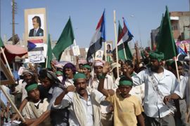 Protesters shout anti-government slogans and hold up flags of former South Yemen and posters of its former president Ali Salem al-Beidh as they take part in a rally in Zinjibar city in the soutnern Abyan province February 28, 2010. Security forces arrested 21 separatists trying to provoke rioting during demonstrations in a southern provincial capital as Yemen increased security to guard against attacks, the government said on Sunday