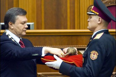 F/Ukraine's President Viktor Yanukovych takes the Bulava, a historical symbol of power, after he taking oath in the parliament in Kiev on February 25, 2010.